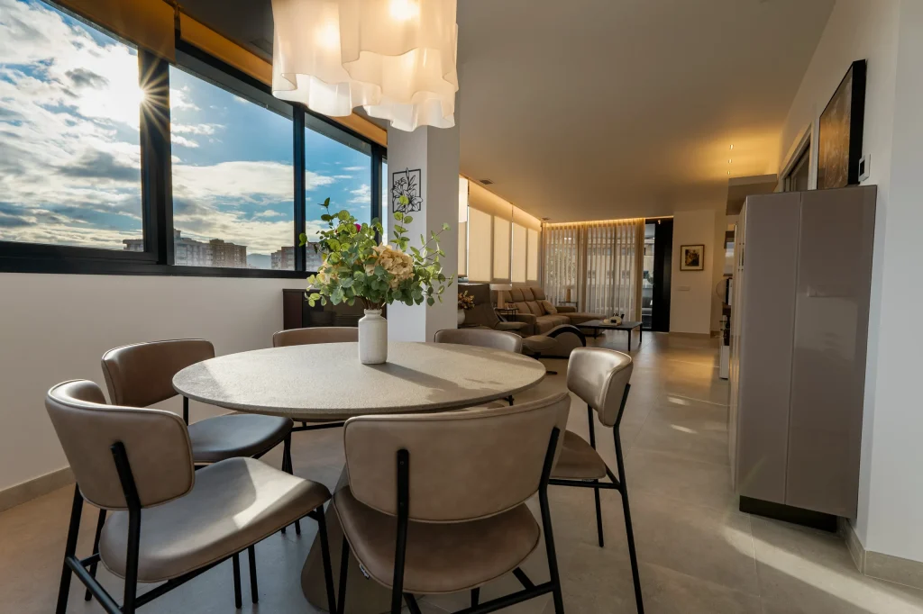 Comedor junto al ventanal con lámpara de diseño